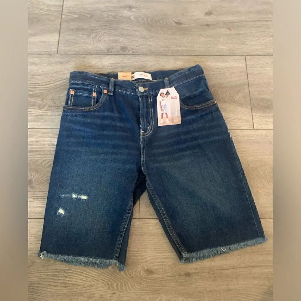 Levis 511 slim shorts that hit at knees and have adjustable waistband
